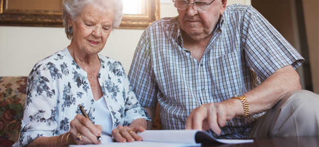 Senior couple doing retirement paperwork
