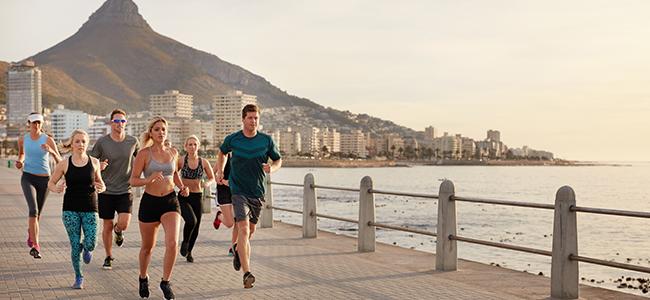 Interracial family, happy portrait and parents on the living room sofa with children, relax in lounge together and smile on the couch. Kids, mother and father with love for senior people in house
