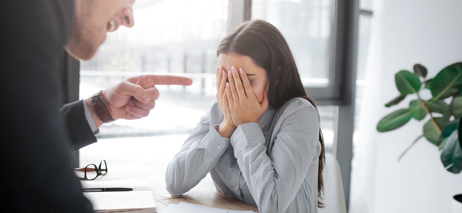 Rude young man point on brunette. She covers face with hands. Model afraid. Guy mad at her. He scream. she cry.